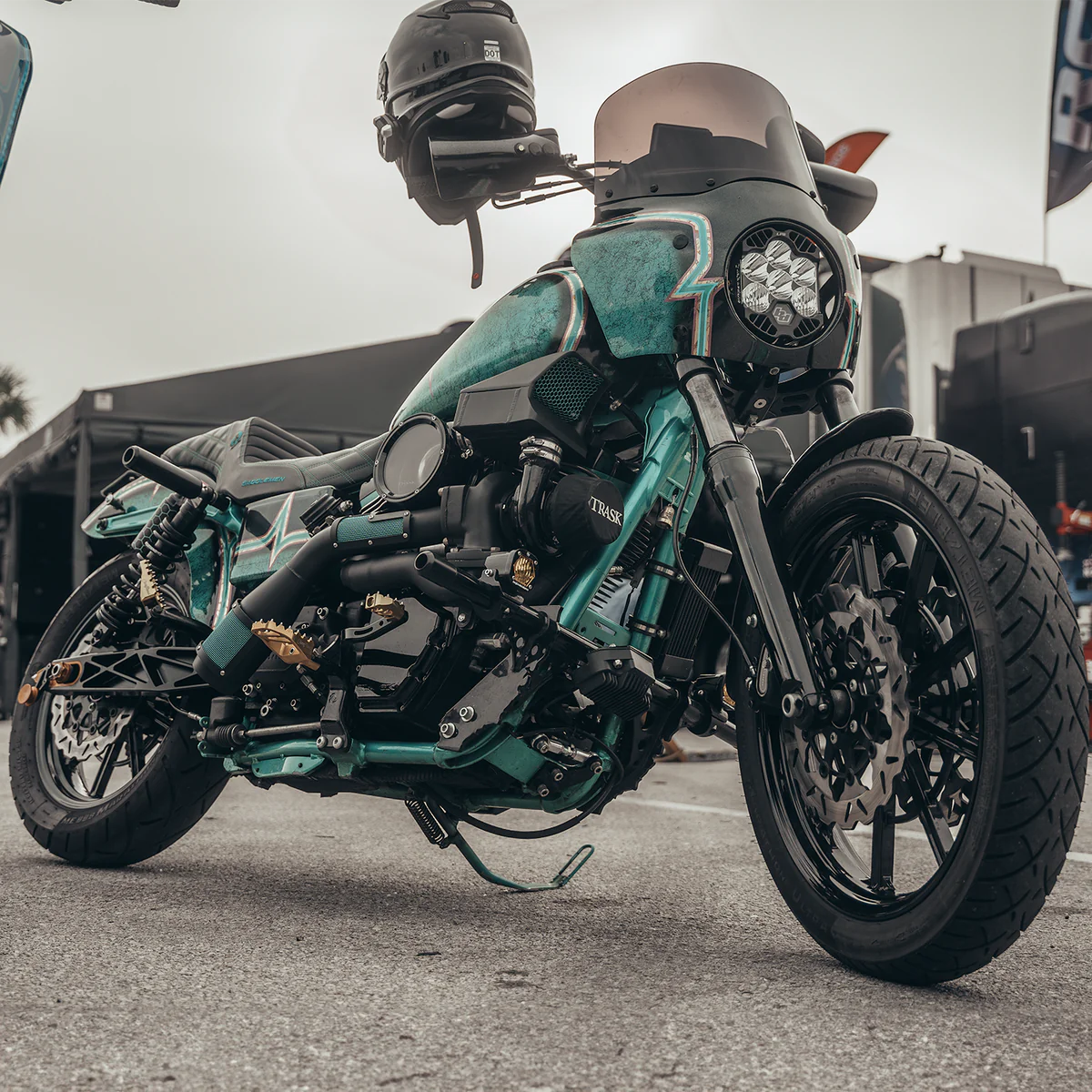 Wide angle photo of a teal Harley Davidson Dyna with the blacked out Trask Dyna assault turbo installed 