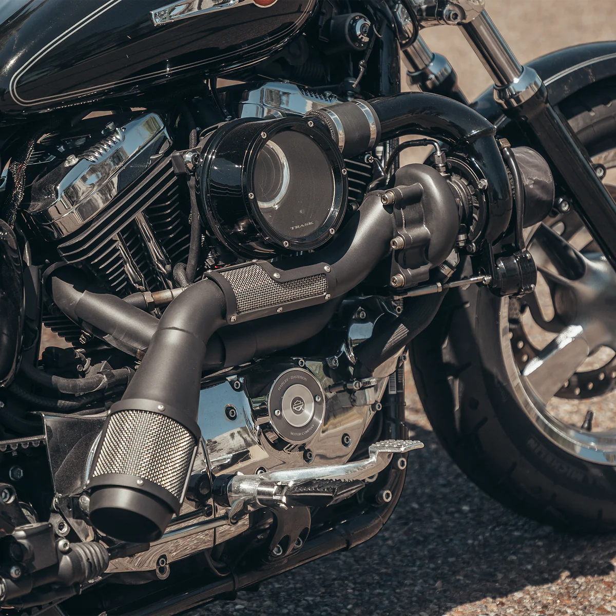 Close up photo of a Harley Davidson sportster with a black on black Trask sportster turbo kit installed 