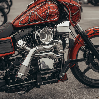 Close up photo of an orange Harley Davidson Dyna with the chrome Trask Dyna assault turbo kit installed 