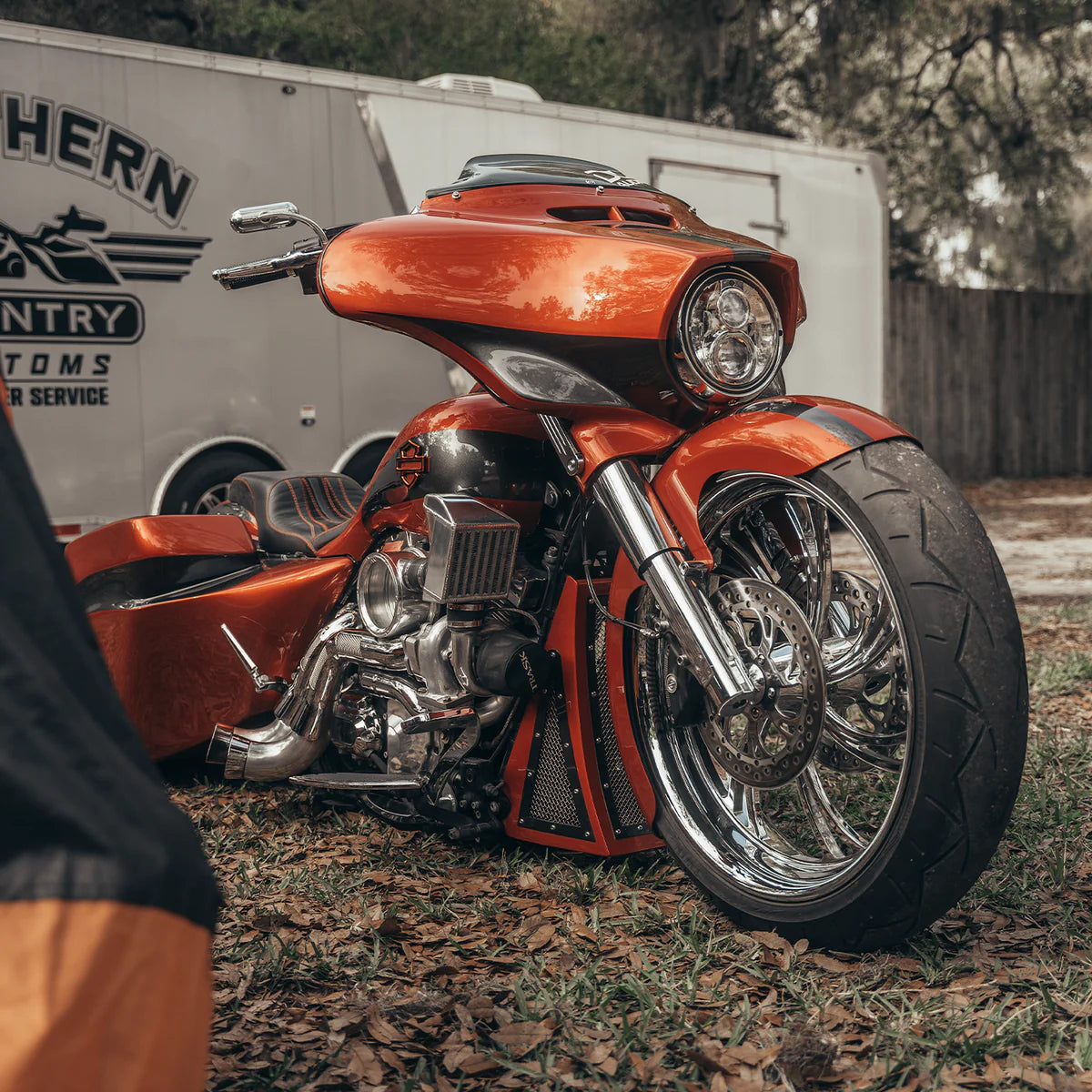 A Red Harley Davidson touring model with a chrome Trask touring typhoon turbo kit installed