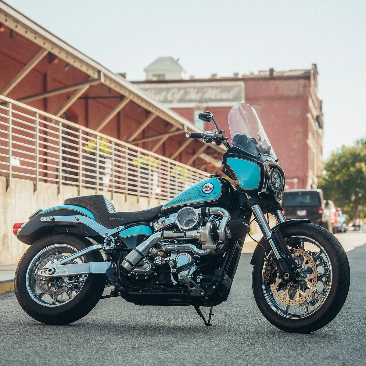 Teal and black Harley Davidson softail with the chrome Trask softail assault turbo kit installed 