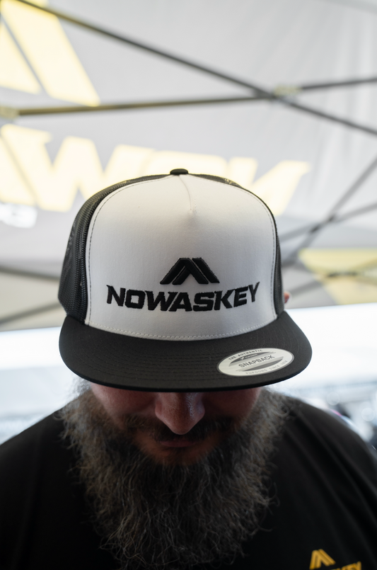 The Nowaskey hat features a sharp black and white design, with a clean white base and detailed black embroidery.