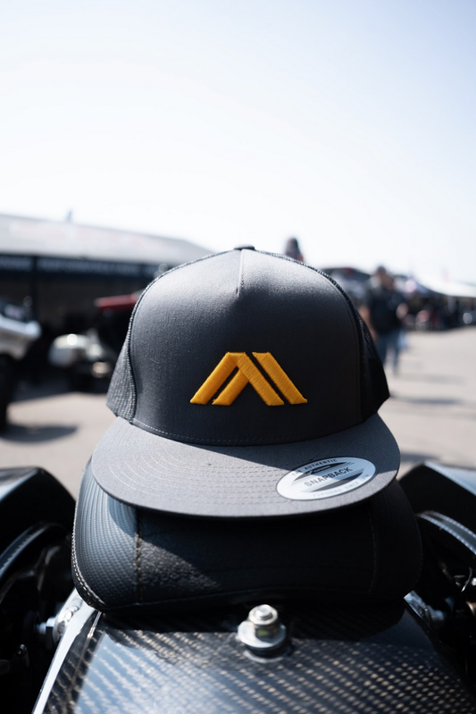 This black Nowaskey snapback hat features a flat brim and adjustable fit, highlighted by bold yellow embroidery for a standout look.