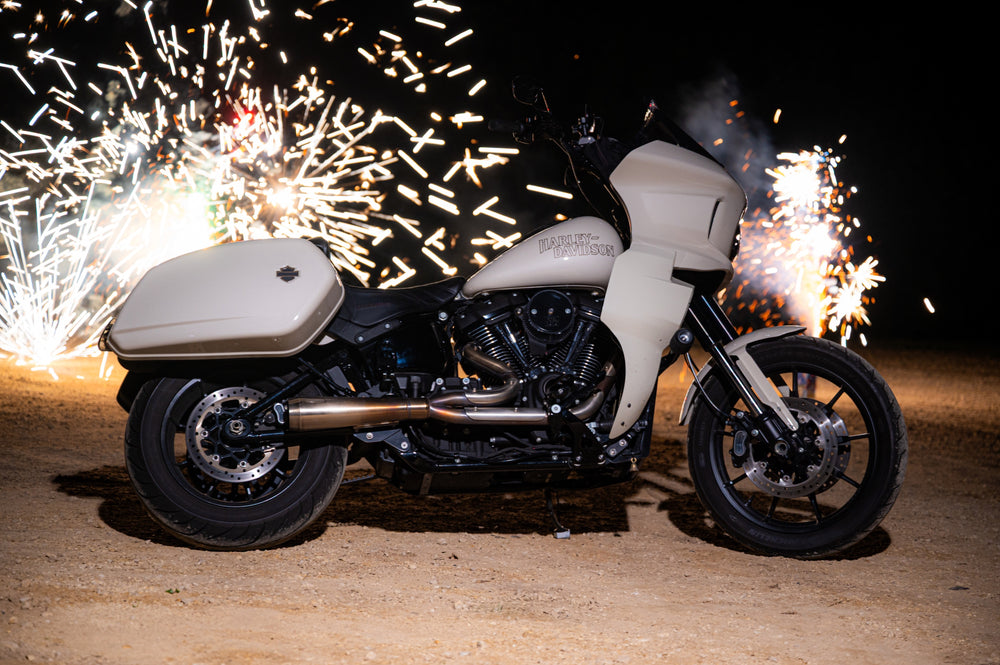 Custom Harley-Davidson Softail ST bagger with fireworks behind it